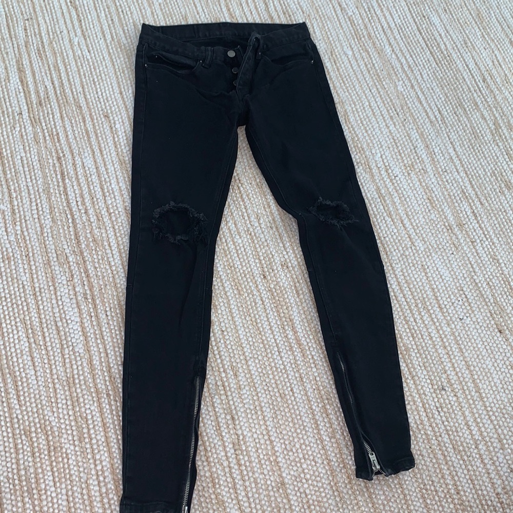 Men’s black jeans with holes in knees and zipper ankle
